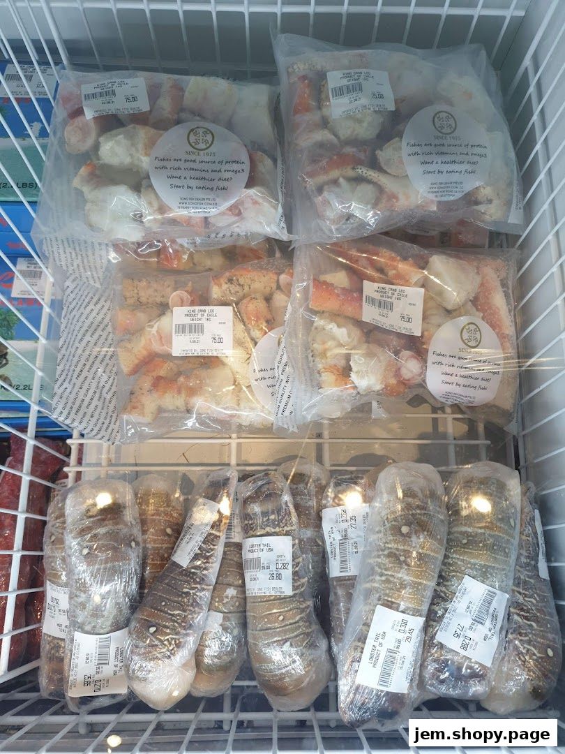 Frozen seafood including king crab legs and lobster tails displayed in a freezer.