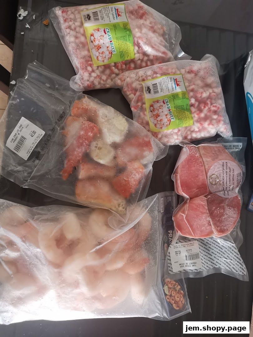 Various frozen seafood products including crab bites, king crab legs, prawns, and tuna steaks.