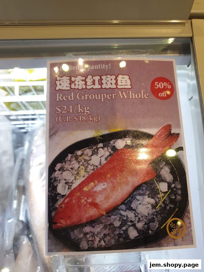 A sign advertising Red Grouper Whole fish with a 50% off discount.