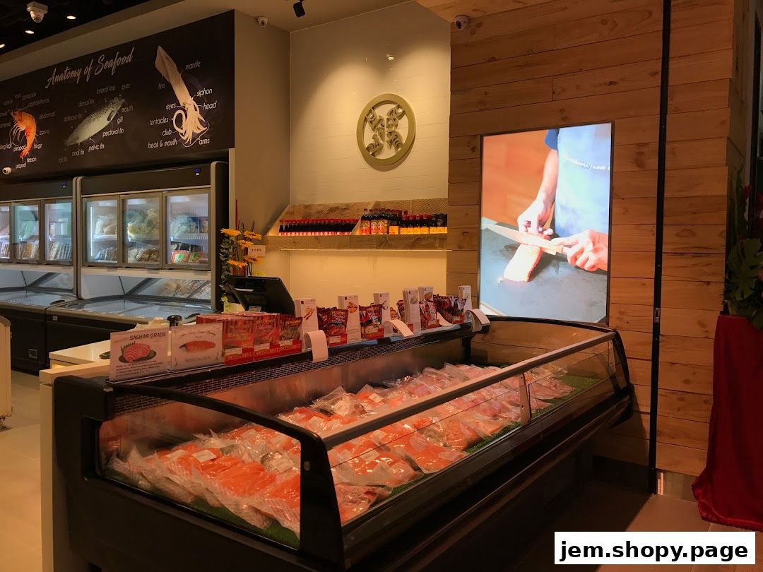 Interior view of a seafood market with fresh fish displayed in refrigerated cases.