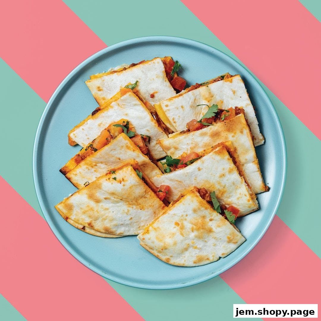 A plate of sliced quesadillas with tomato and cilantro filling on a blue plate.