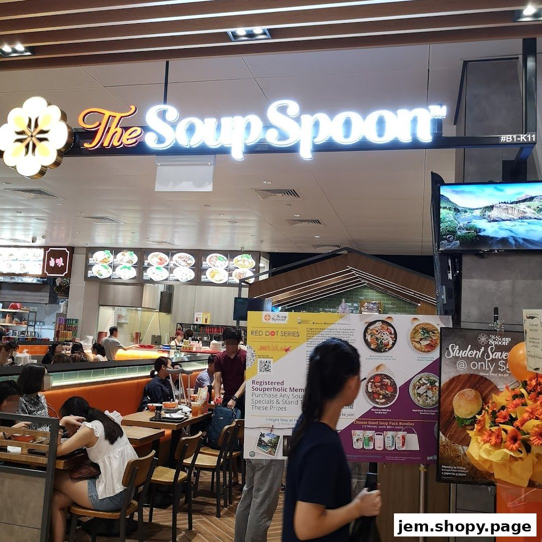 The Soup Spoon restaurant interior with customers and promotional posters.