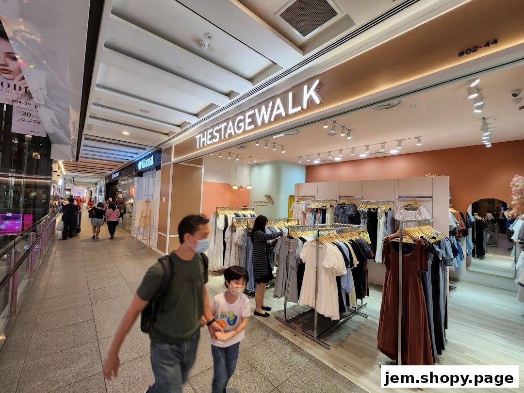 The Stage Walk clothing store entrance with racks of dresses and apparel on display.
