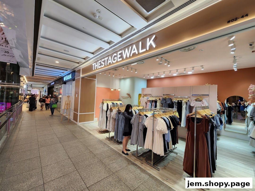 The Stage Walk shop front displays a variety of women's clothing on racks.