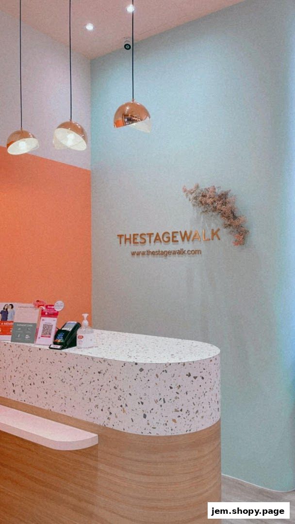 The reception area of The Stage Walk features a terrazzo counter and modern pendant lights.