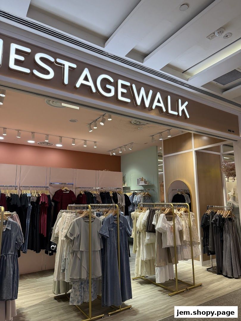 The Stage Walk clothing store entrance with racks of women's apparel displayed.