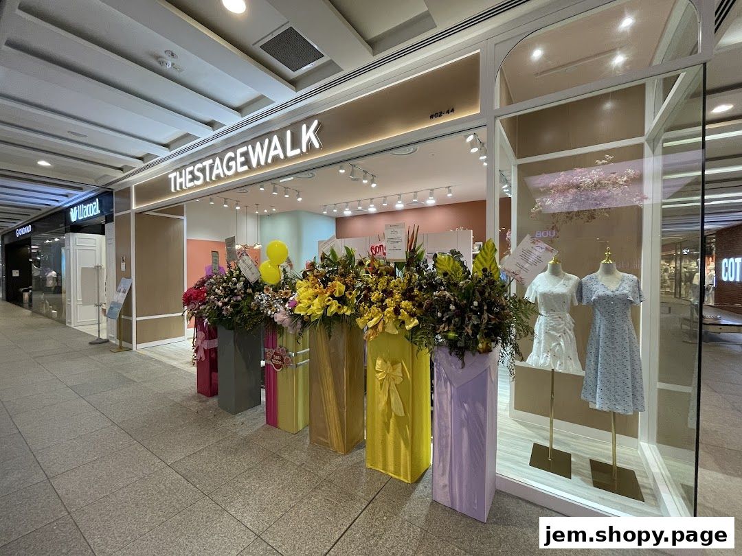 The Stage Walk shop front with floral displays and mannequins showcasing dresses.