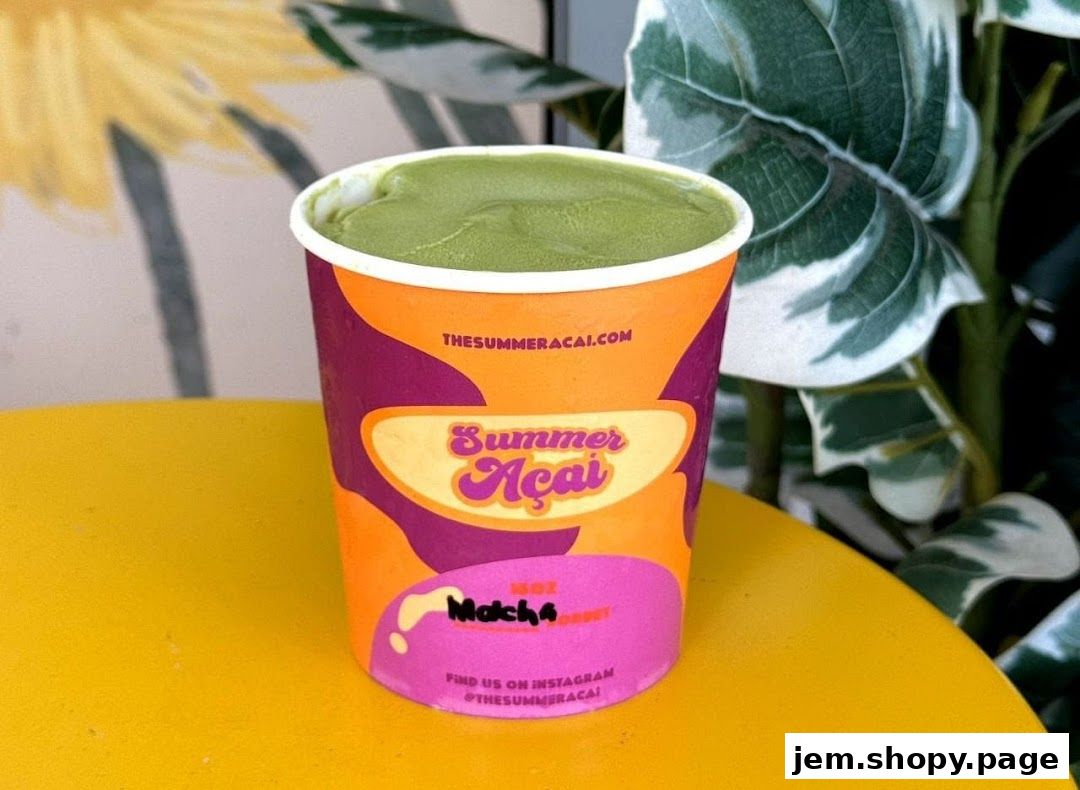 A cup of green matcha açaí from The Summer Açaí with vibrant branding.