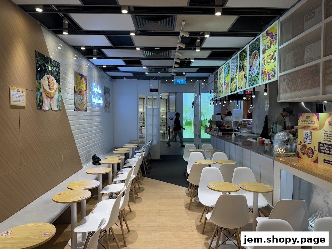 Interior view of The Summer Açaí shop with seating, counter, and menu displays.