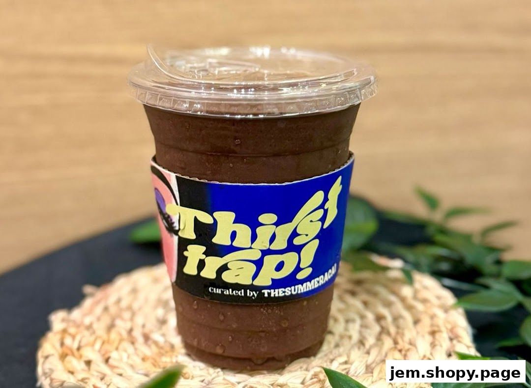 A refreshing iced beverage in a clear cup with a colorful sleeve.