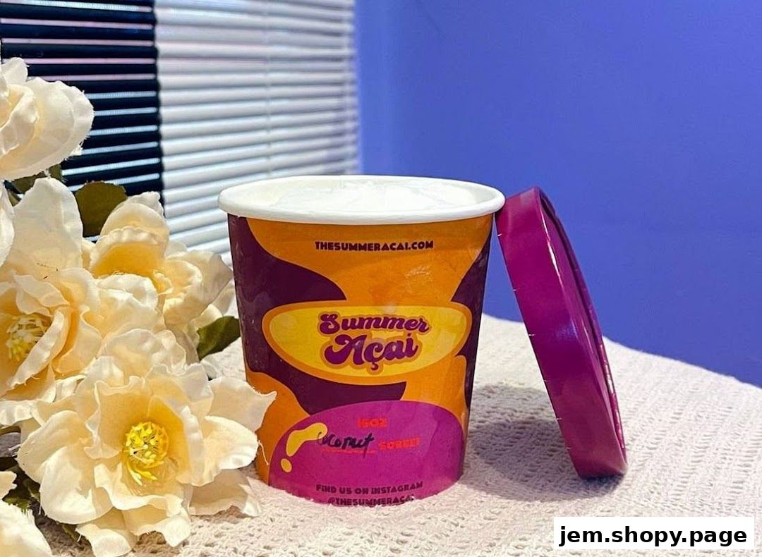 A tub of Summer Açaí coconut sorbet with a purple lid and flowers.