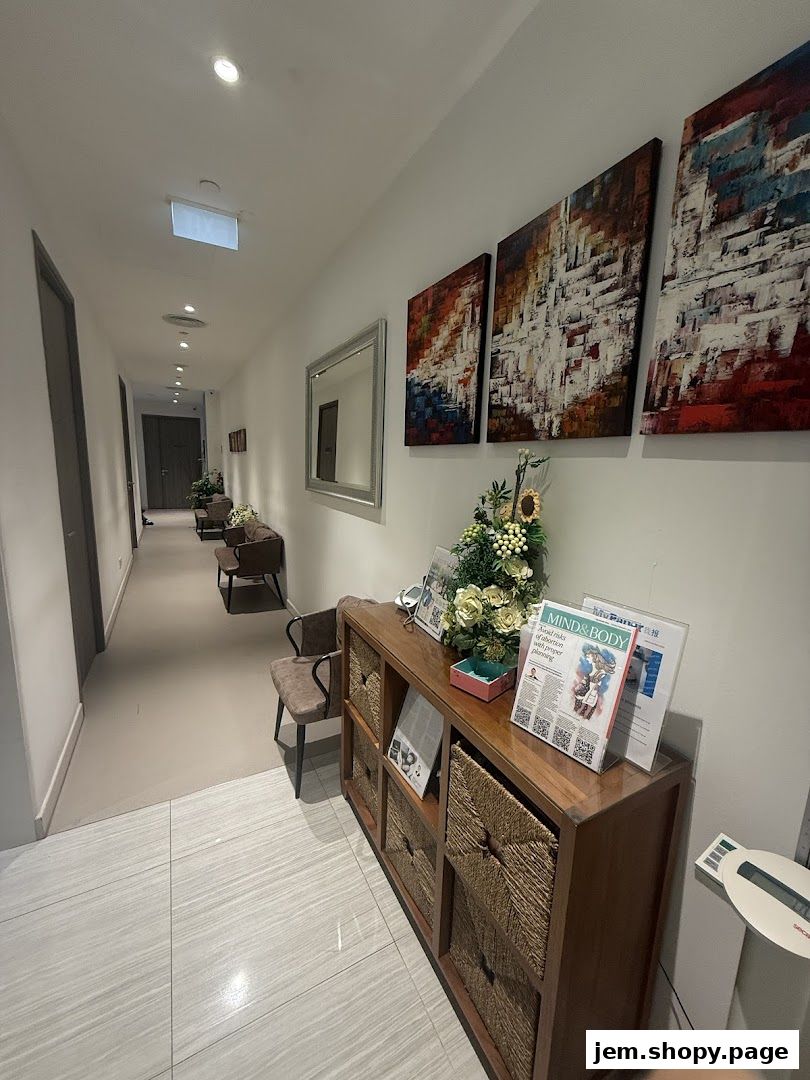 A clinic waiting area with artwork, seating, and informational brochures.