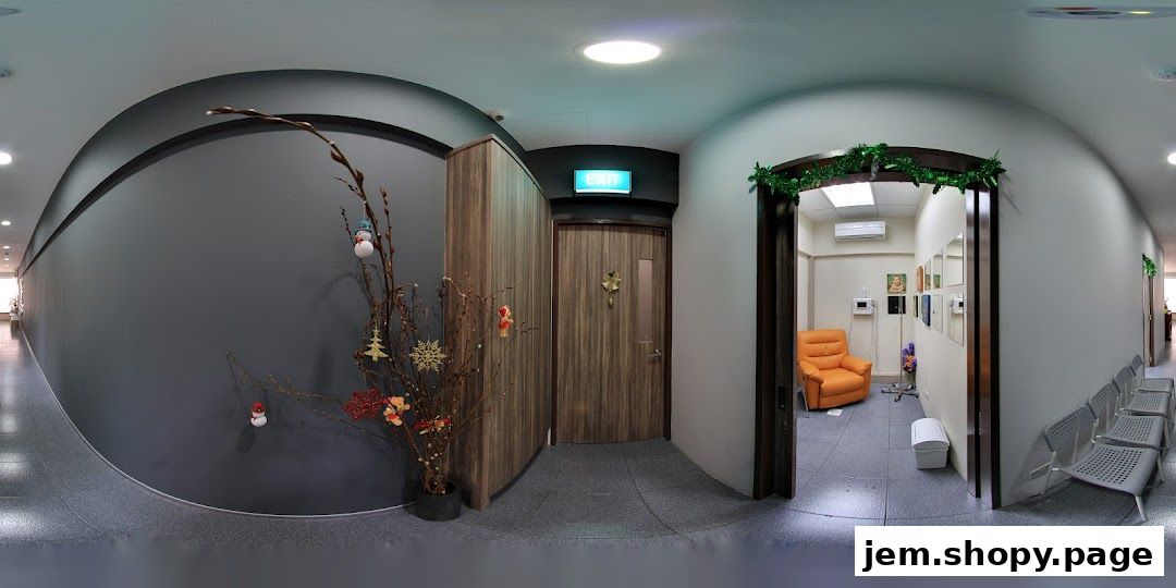 Interior view of a clinic hallway with an orange chair and waiting area.