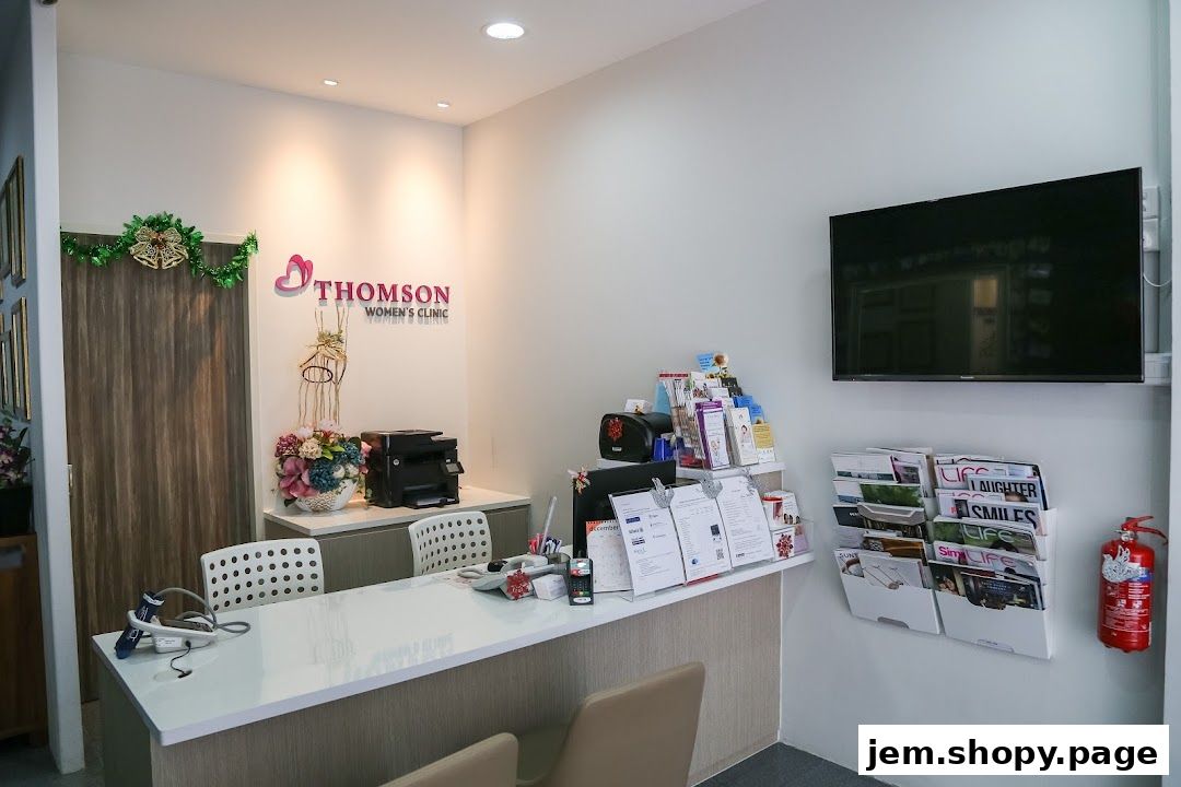 Reception area of Thomson Women's Clinic with a desk, chairs, and health-related brochures.