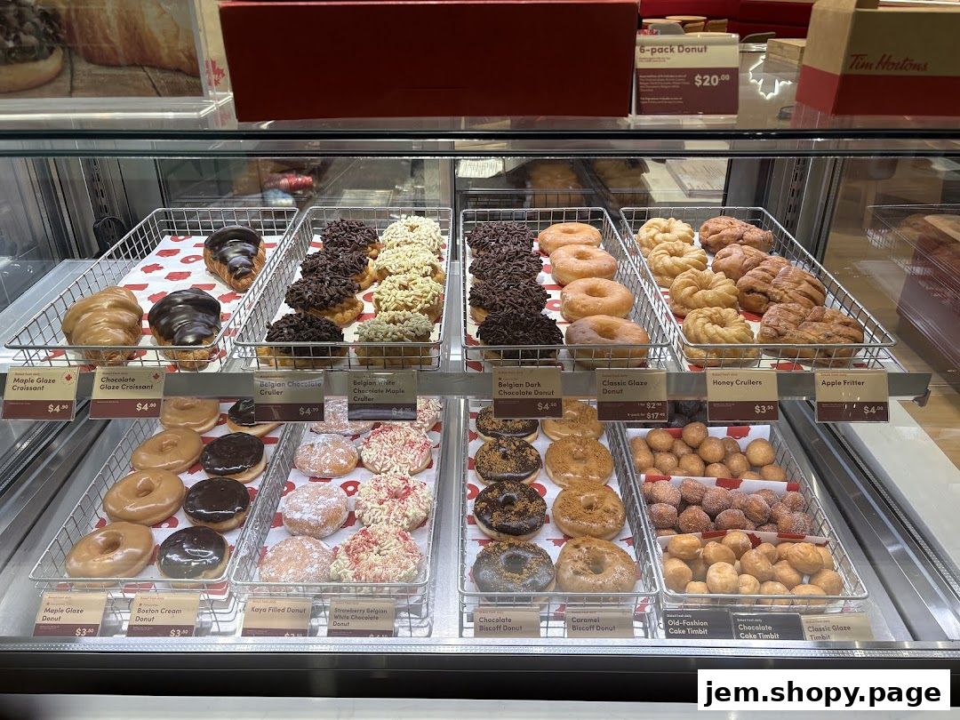 A display case filled with various donuts, croissants, and Timbits at Tim Hortons.