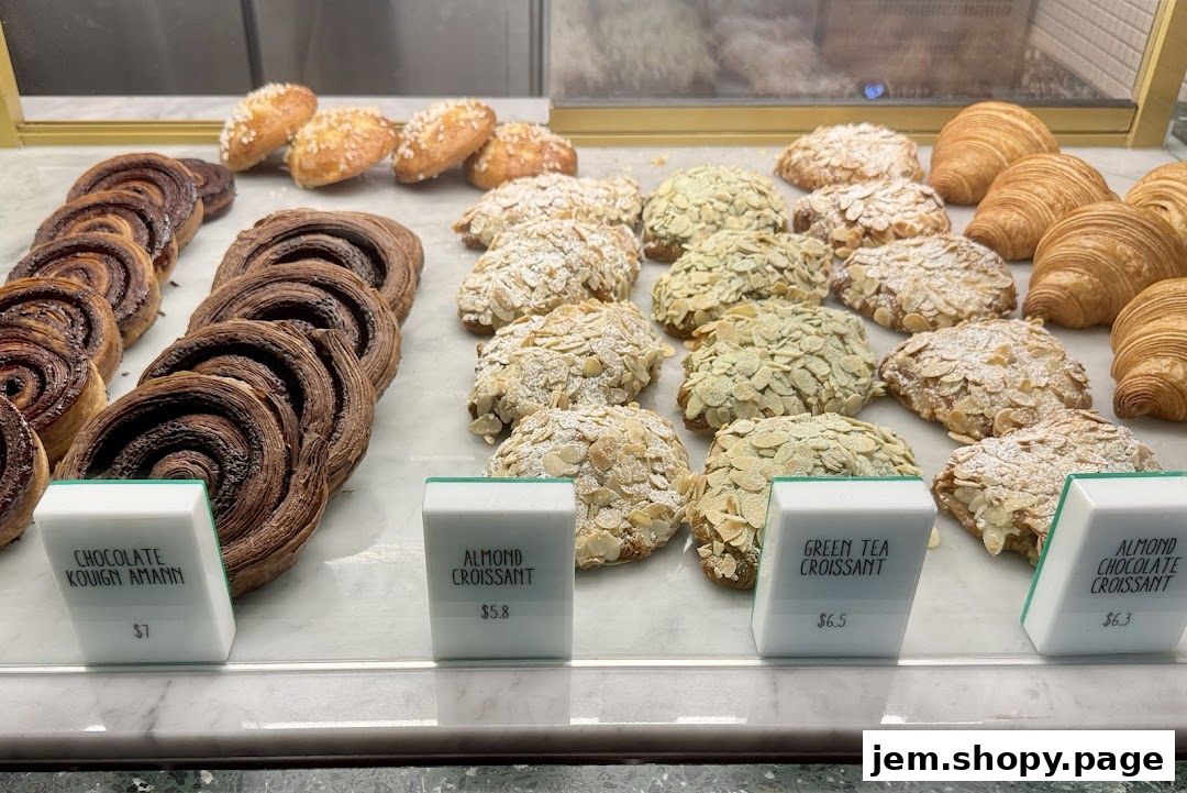A display of freshly baked pastries including croissants and kouign amann.