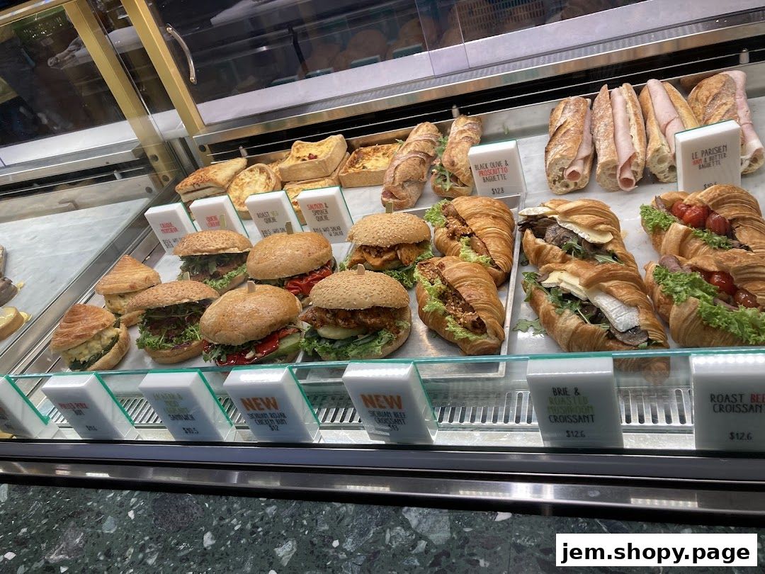 A display case filled with various sandwiches, croissants, and quiches from Tiong Bahru Bakery.