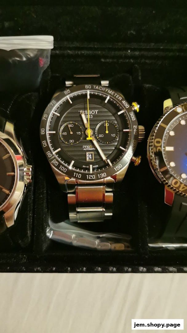 A close-up of a Tissot chronograph watch with a black dial and yellow accents.