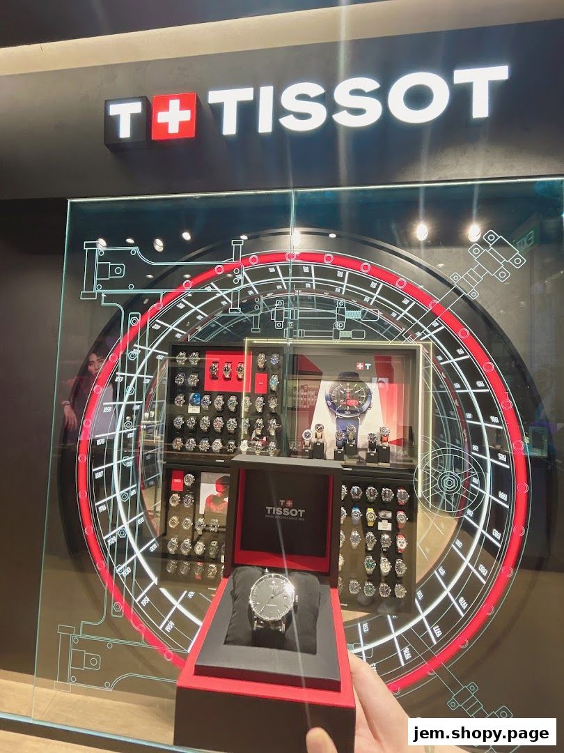 A Tissot watch shop display featuring a watch in a box and various watches on shelves.