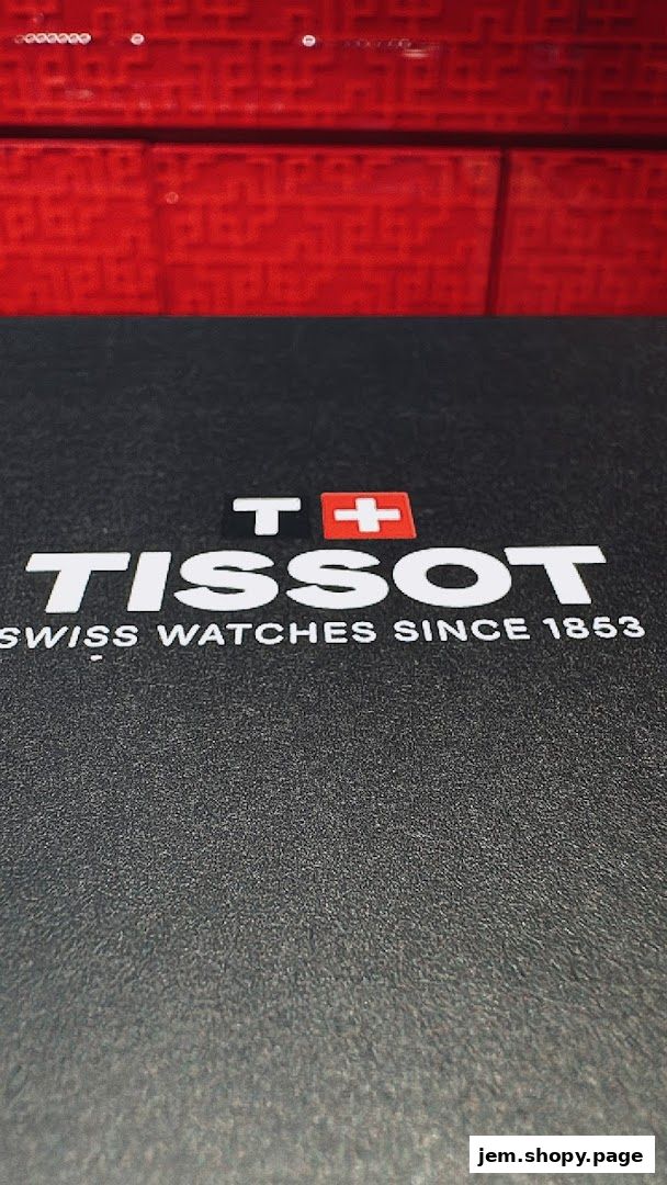 Tissot logo and slogan on a textured black surface with a red patterned background.