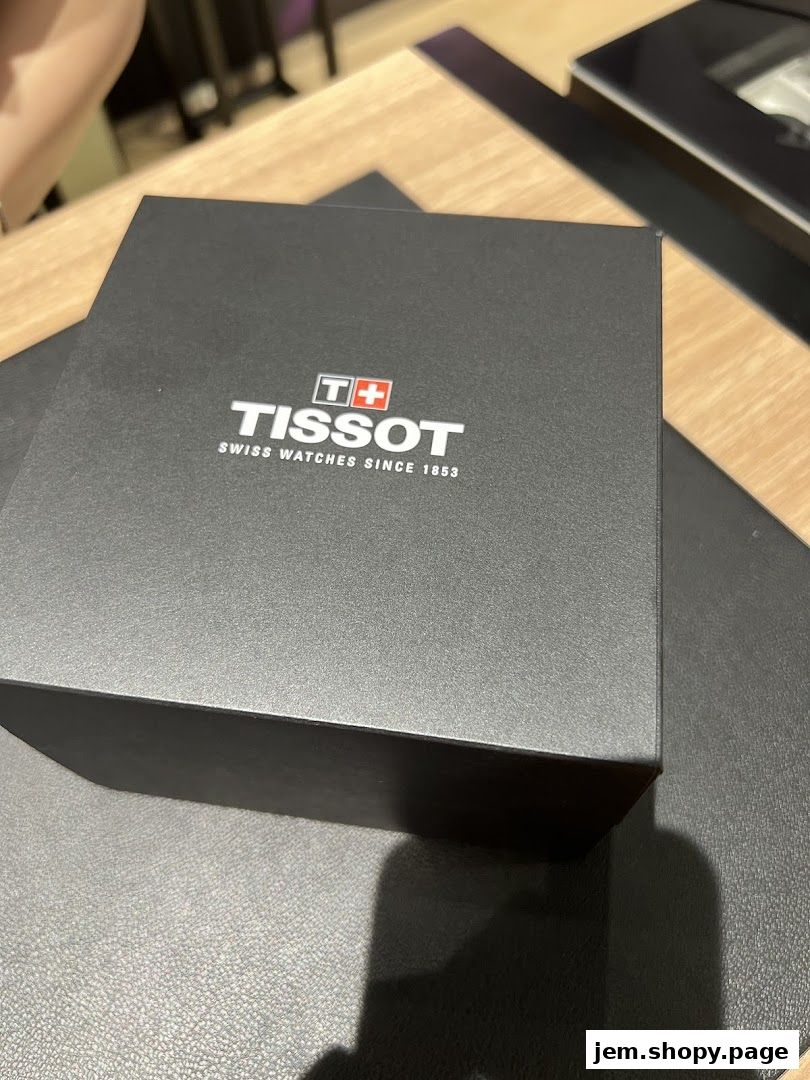 A black Tissot watch box with the brand logo and tagline.