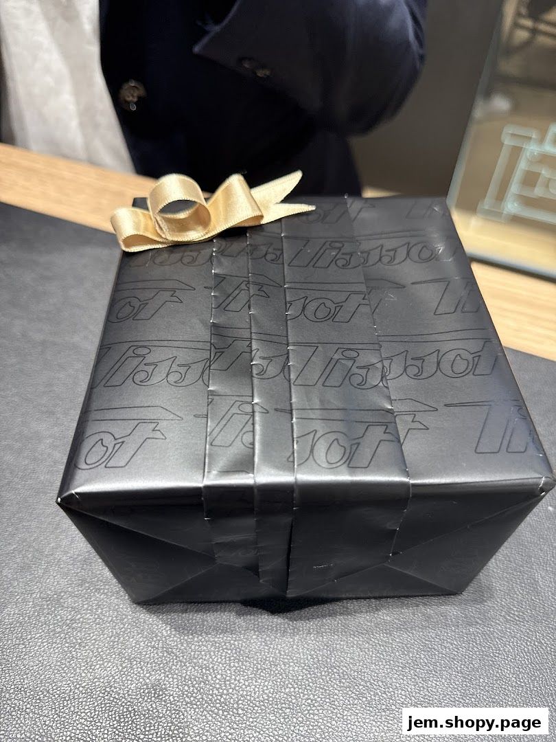 A gift-wrapped box with Tissot branding and a gold ribbon.