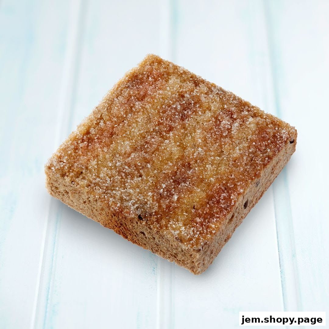 A close-up shot of a square piece of toast covered in sugar.