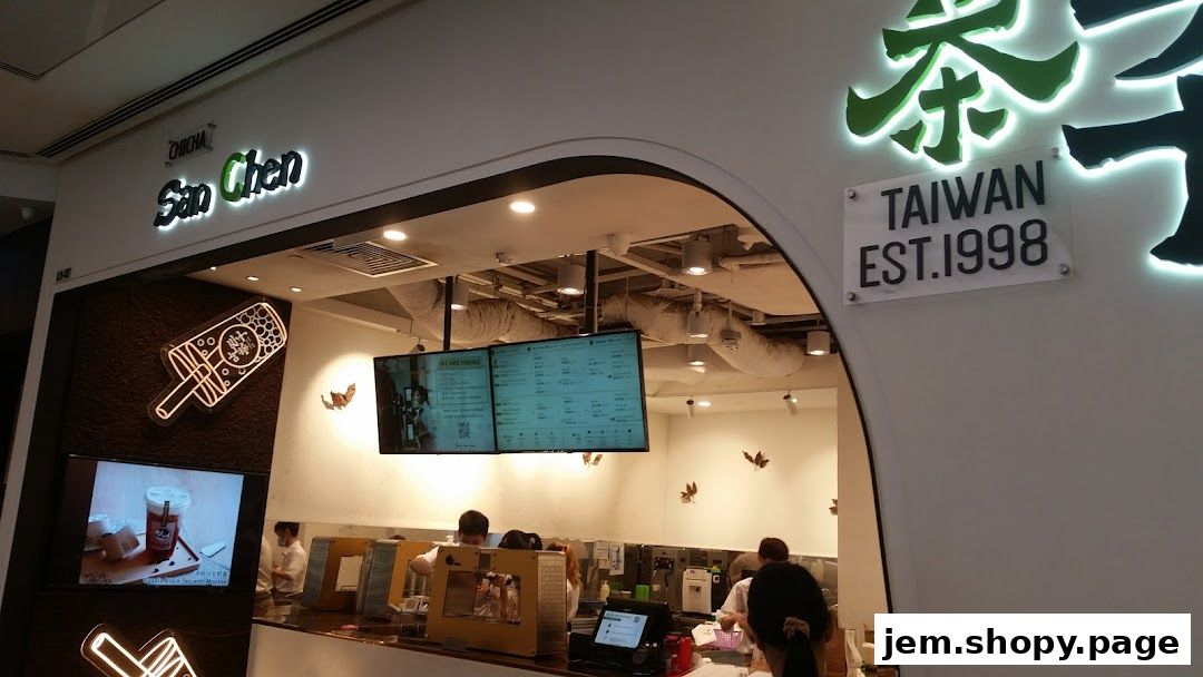 Interior view of a San Chen bubble tea shop with a menu board and staff serving customers.
