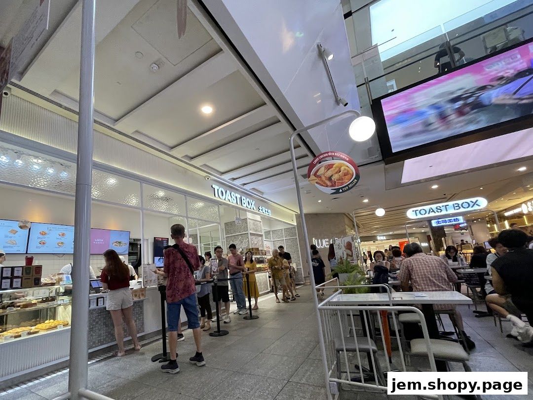 A Toast Box shop with customers queuing and dining at tables.