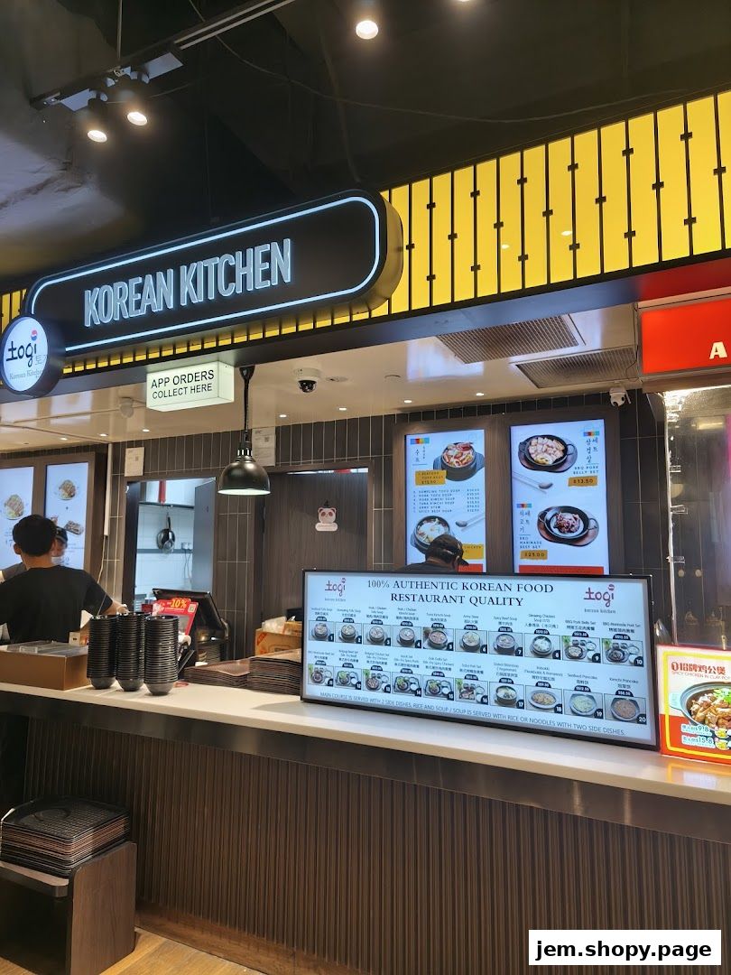 The exterior of Togi Korean Kitchen with a prominent sign and menu display.