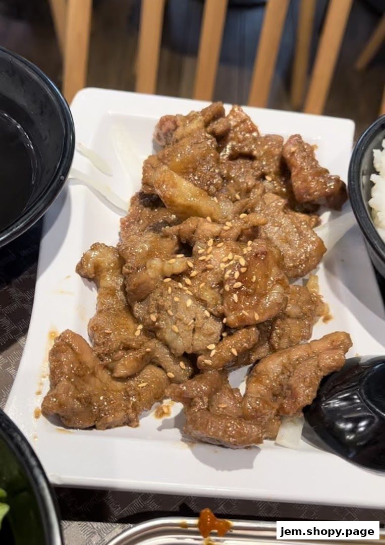 A plate of delicious, glazed Korean BBQ meat with sesame seeds.