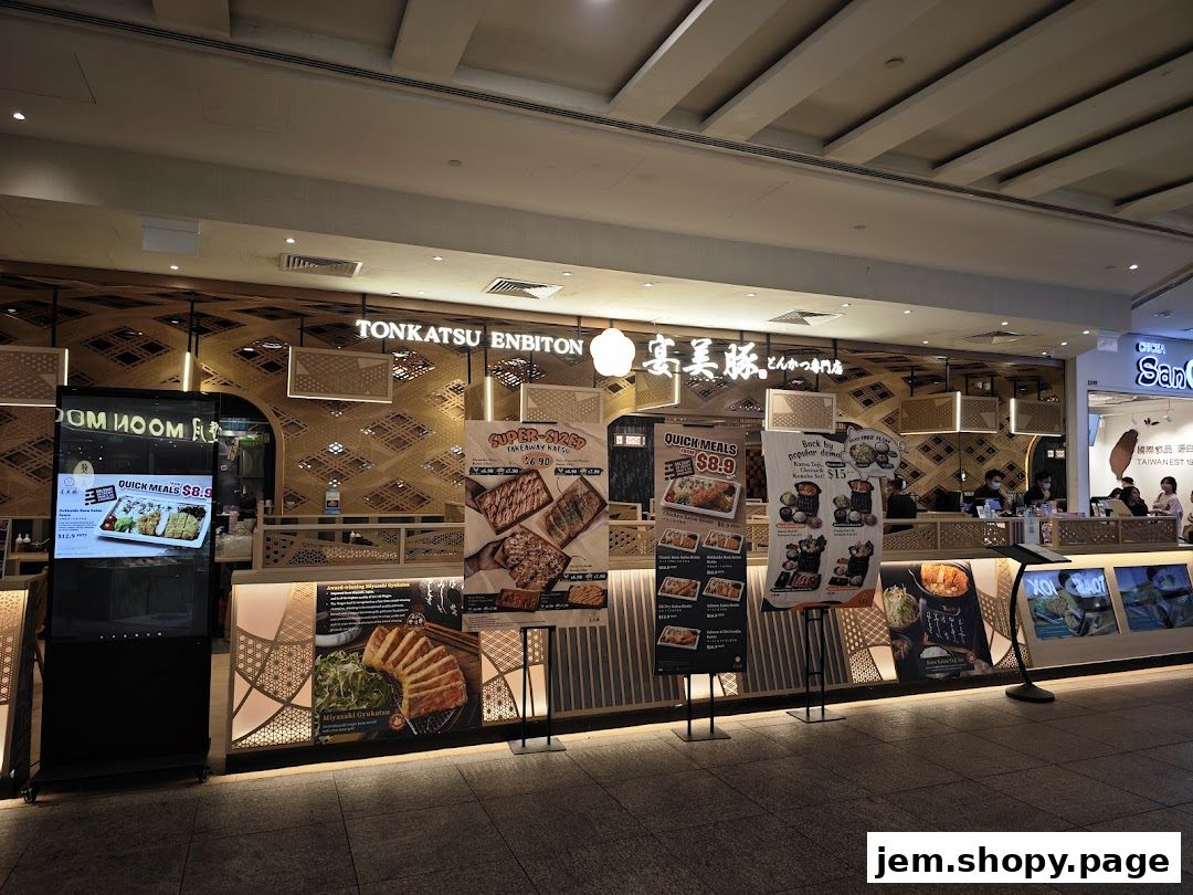The exterior of Tonkatsu ENbiton Jem, a Japanese restaurant, with promotional posters displayed.