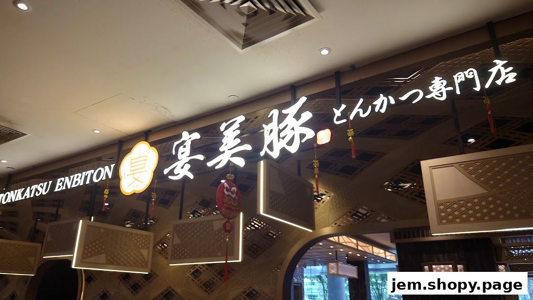 The illuminated sign for Tonkatsu ENbiton restaurant with decorative elements.