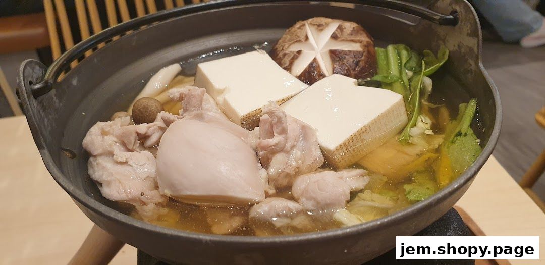 A hot pot dish with chicken, tofu, mushrooms, and vegetables in a savory broth.