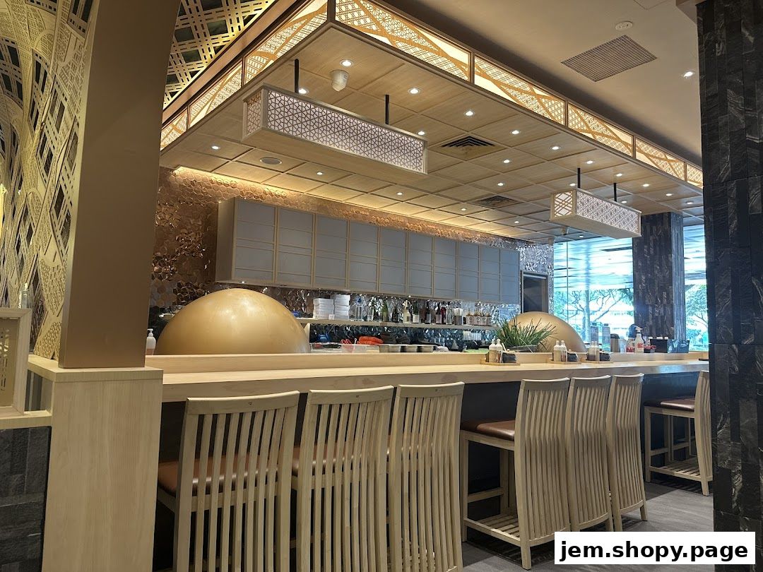 Interior view of a modern Japanese restaurant with a sushi bar and seating.