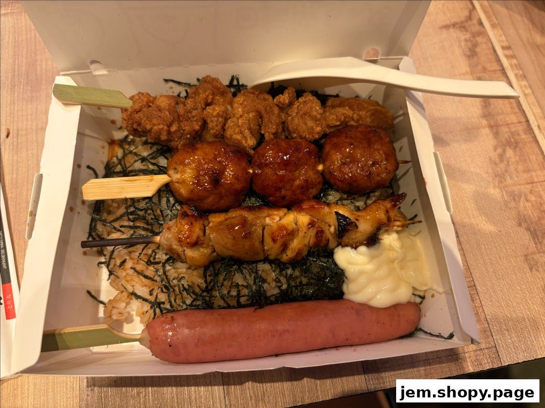 A bento box filled with various grilled skewers, rice, and a sausage.
