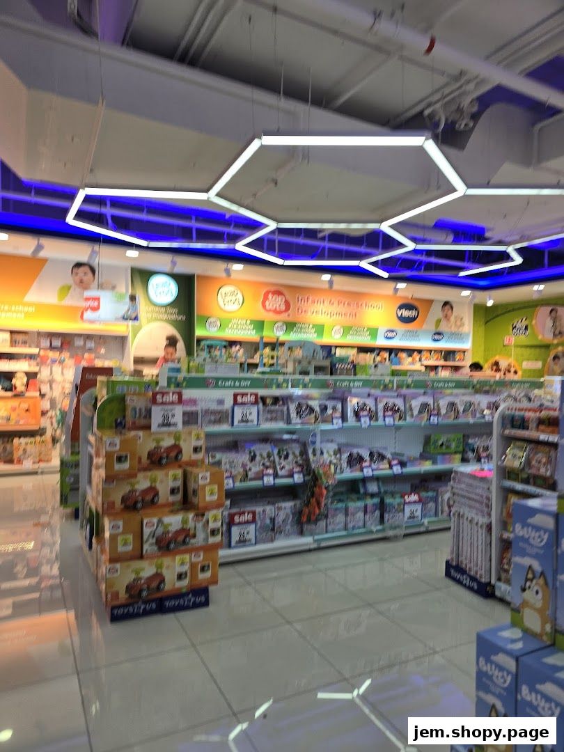 Interior view of a Toys R Us store showcasing shelves filled with toys and promotional signage.
