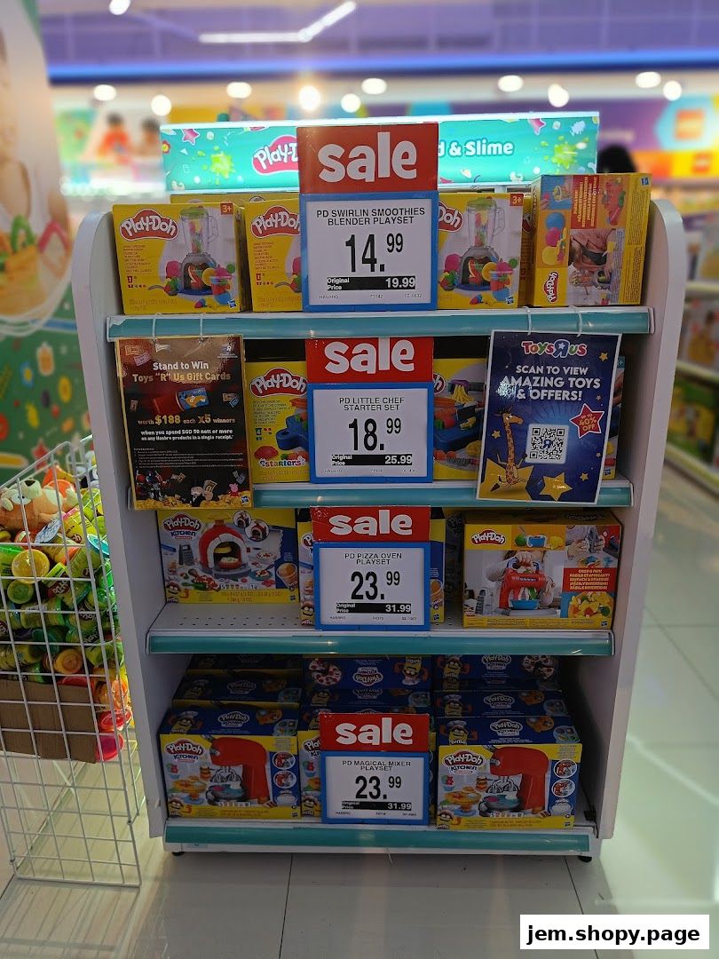 A display shelf in Toys "R" Us featuring Play-Doh sets on sale.