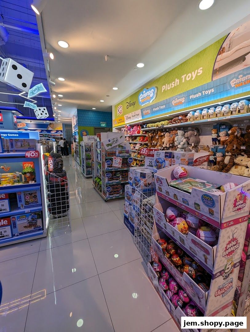 Interior view of a Toys R Us store with aisles of toys, plush toys, and games.