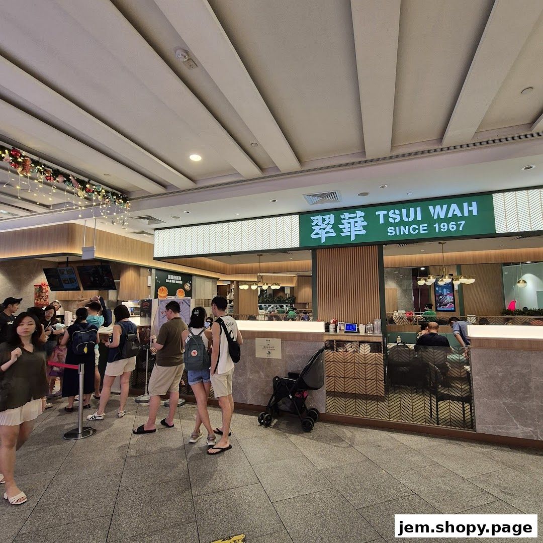 People queuing outside Tsui Wah restaurant with its prominent green signage.