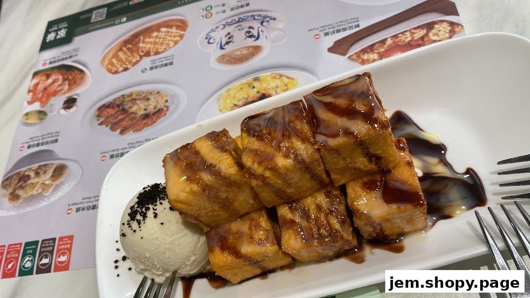A close-up of a dessert with ice cream and a menu featuring various food items.