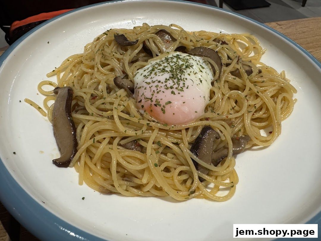 A plate of spaghetti with mushrooms and a poached egg, garnished with herbs.