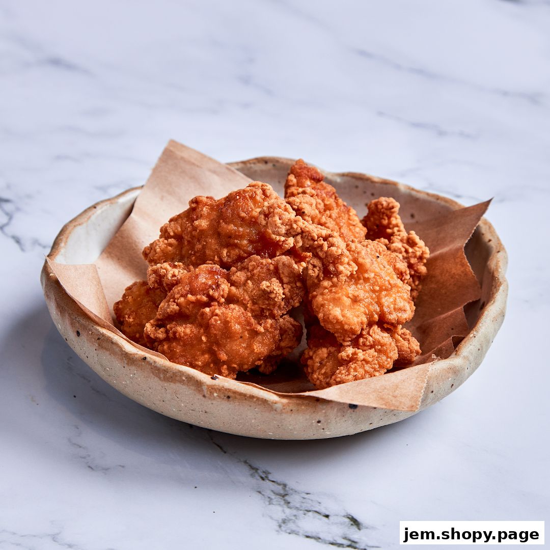 A close-up shot of crispy fried chicken pieces served in a rustic bowl.