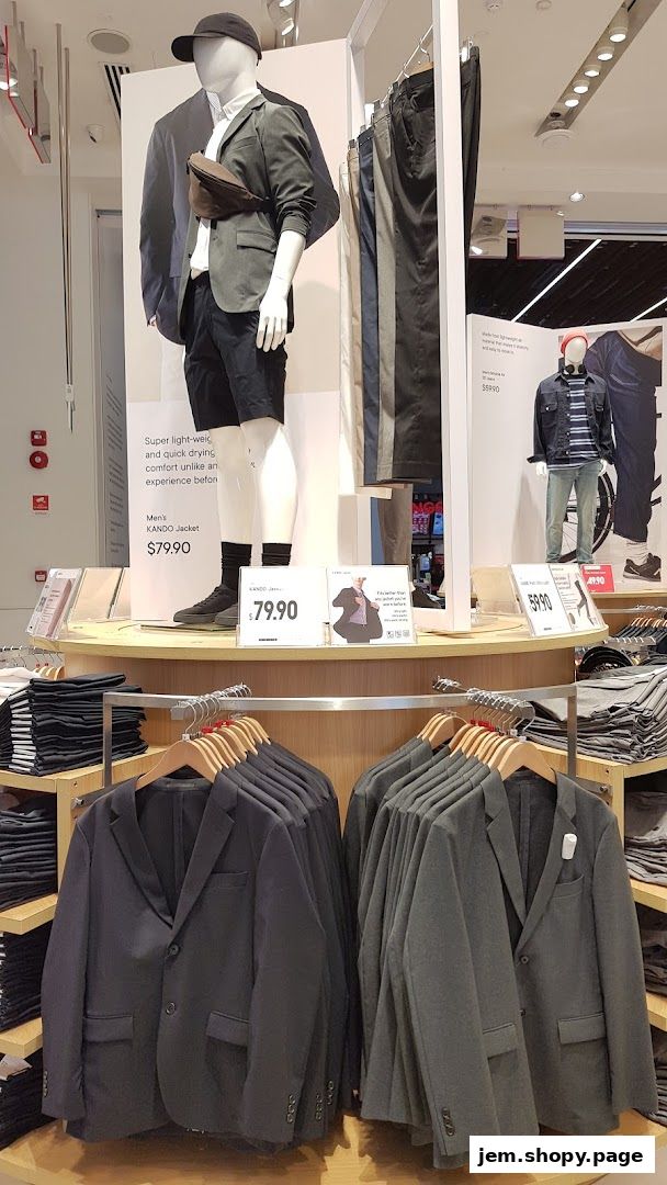 Mannequins display Uniqlo jackets and pants, with folded clothes and jackets on racks.