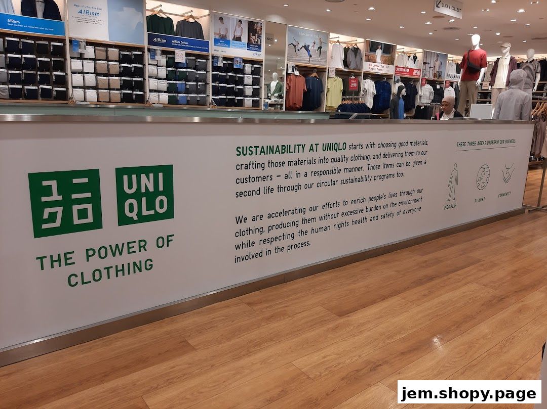 UNIQLO store interior showcasing clothing displays and a sustainability message.