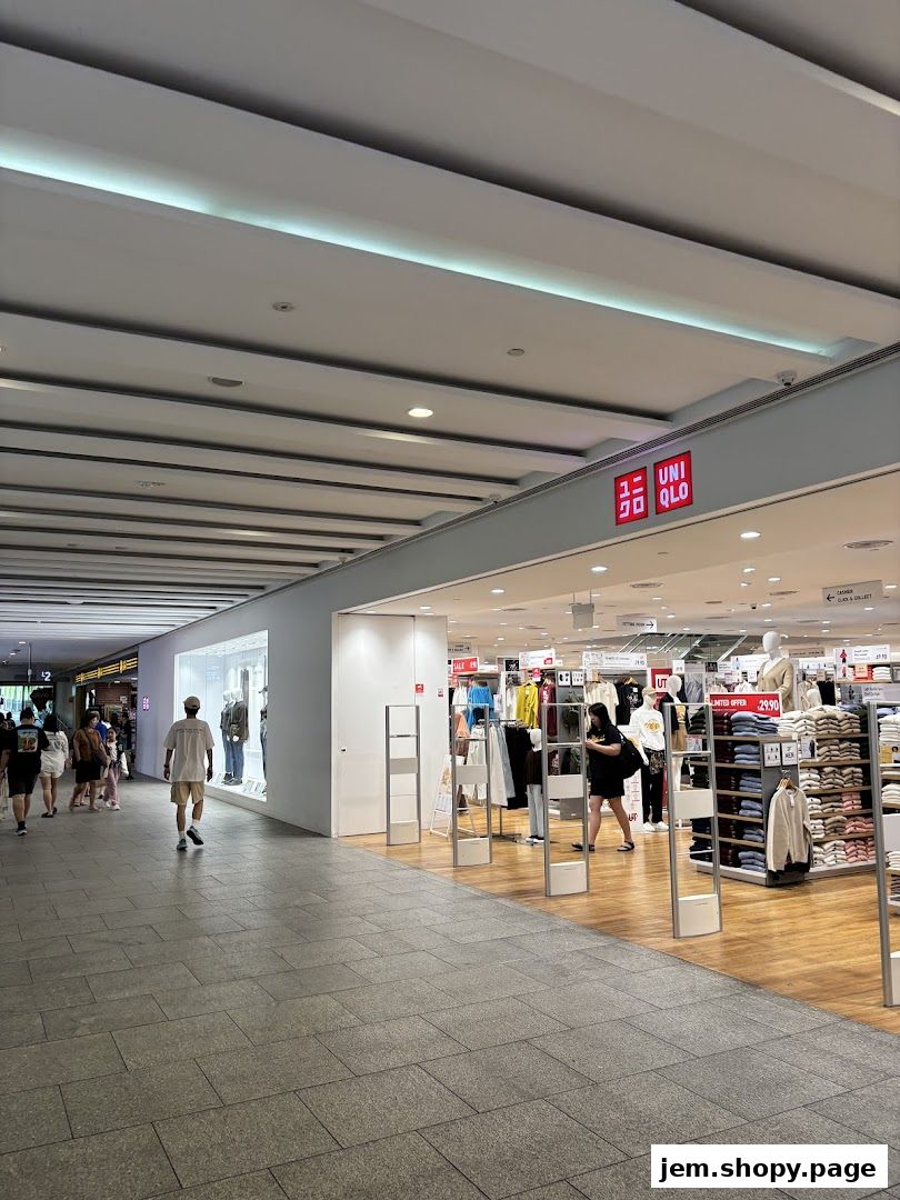 The entrance to a UNIQLO store with clothing displays and mannequins visible inside.