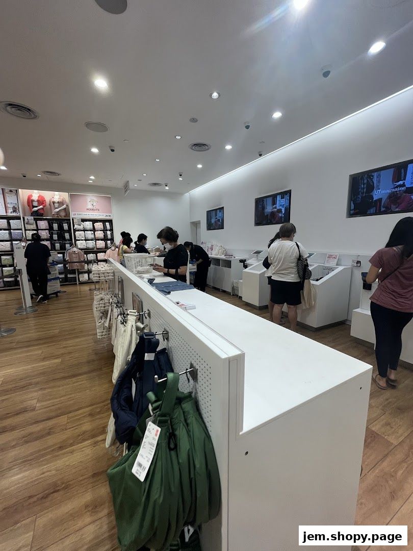 Interior view of a UNIQLO store with customers browsing and staff assisting.