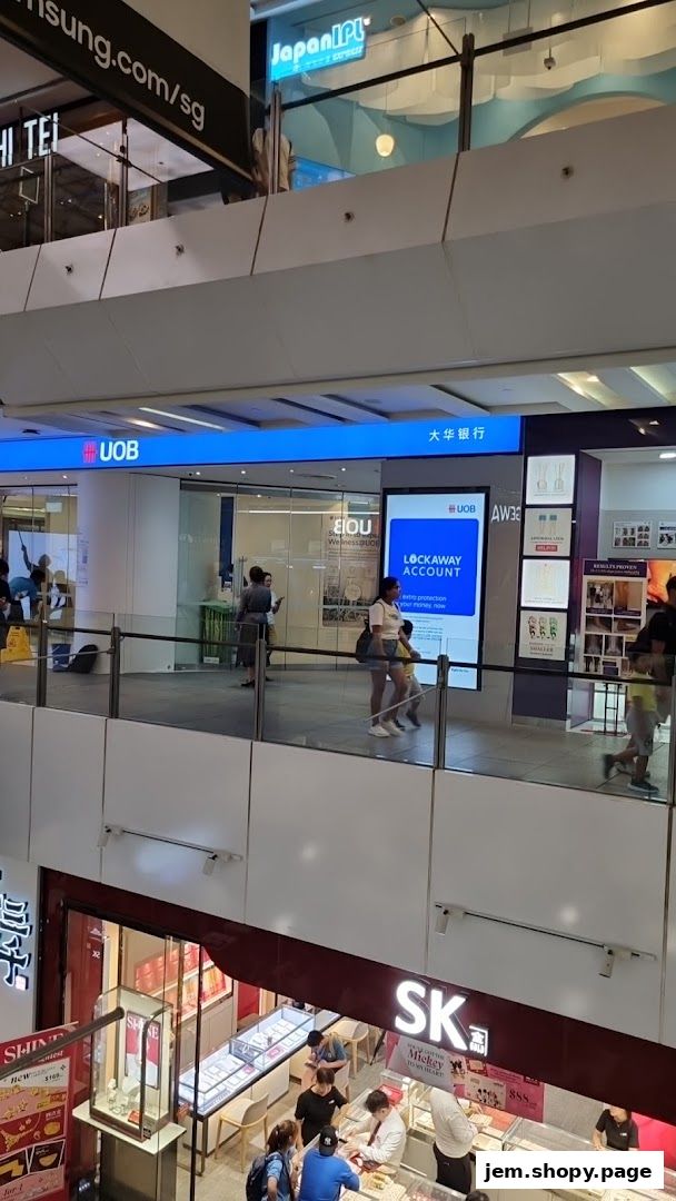 Exterior view of the UOB Bank branch and other shops within a mall.