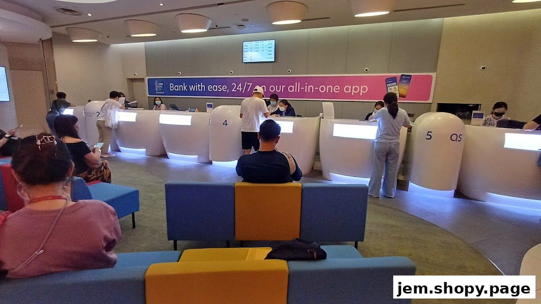Interior of a UOB bank branch with customers at counters and waiting areas.