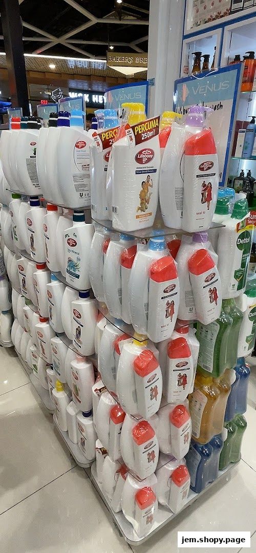 A display of various body wash and hand soap bottles, neatly arranged on shelves.